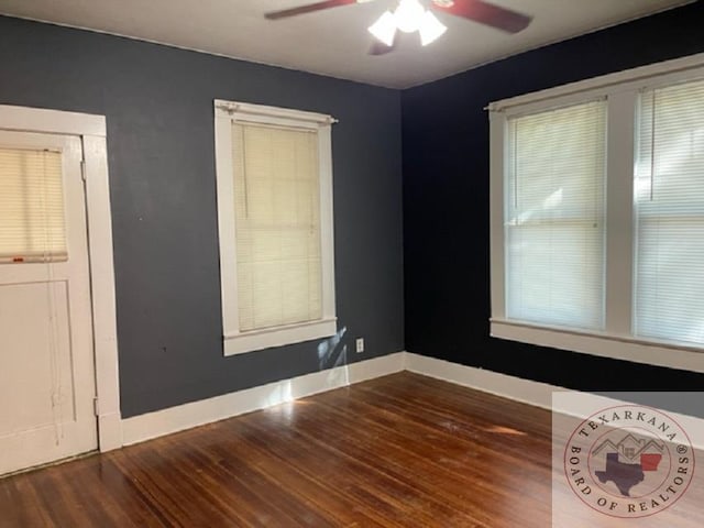 empty room featuring ceiling fan and dark wood-type flooring