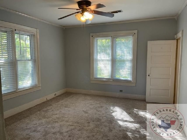 carpeted empty room featuring ceiling fan and crown molding