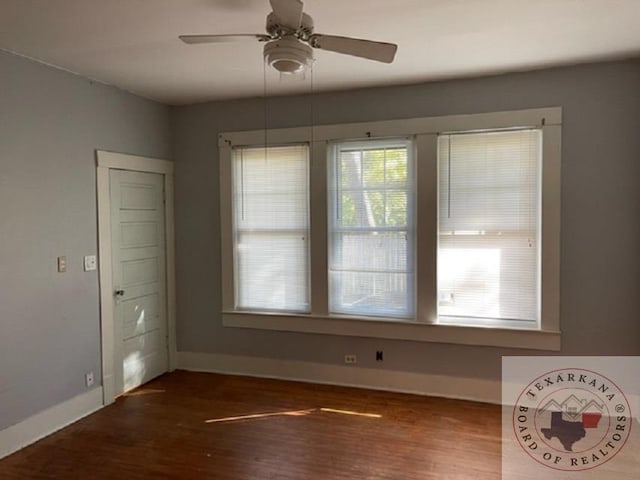 unfurnished dining area with ceiling fan, plenty of natural light, and dark hardwood / wood-style flooring