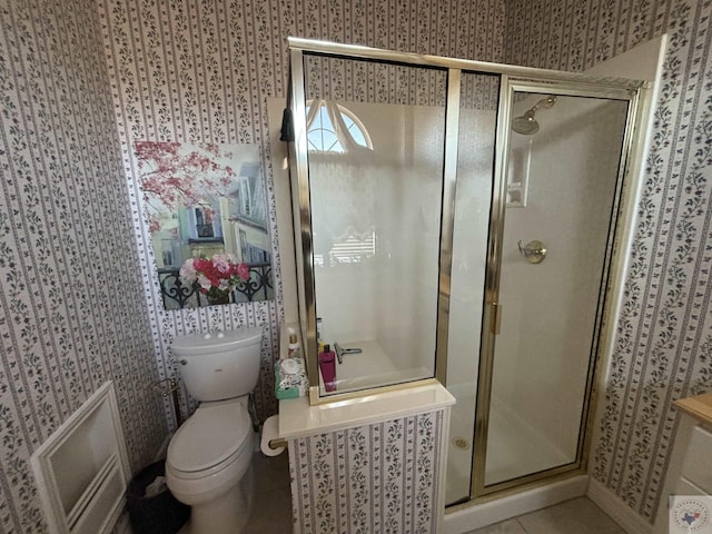 bathroom with toilet, tile patterned flooring, and an enclosed shower