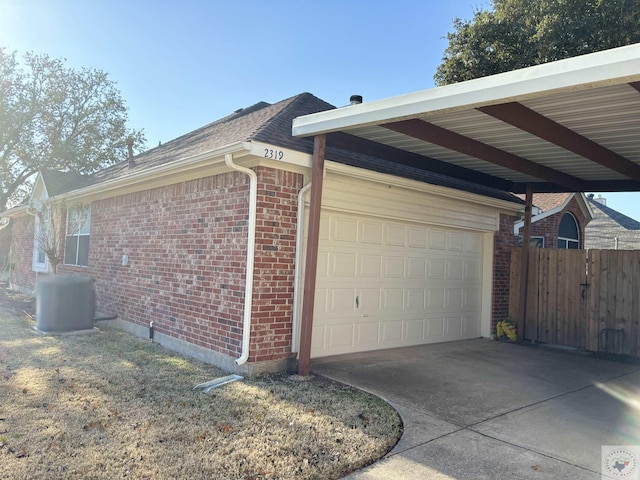 view of side of property with a garage, central air condition unit, and a carport