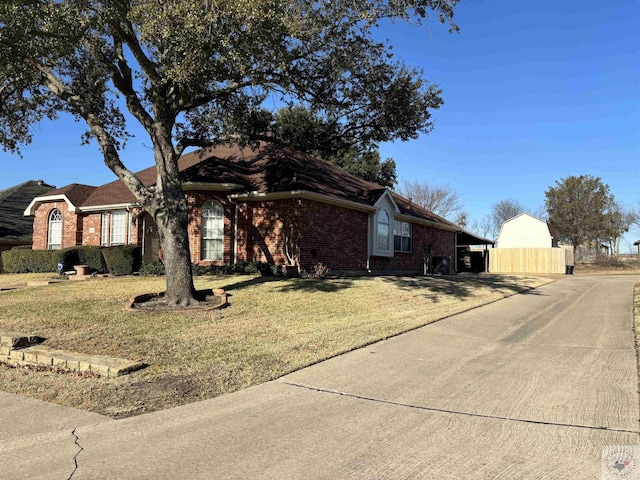 single story home featuring a front yard and a carport