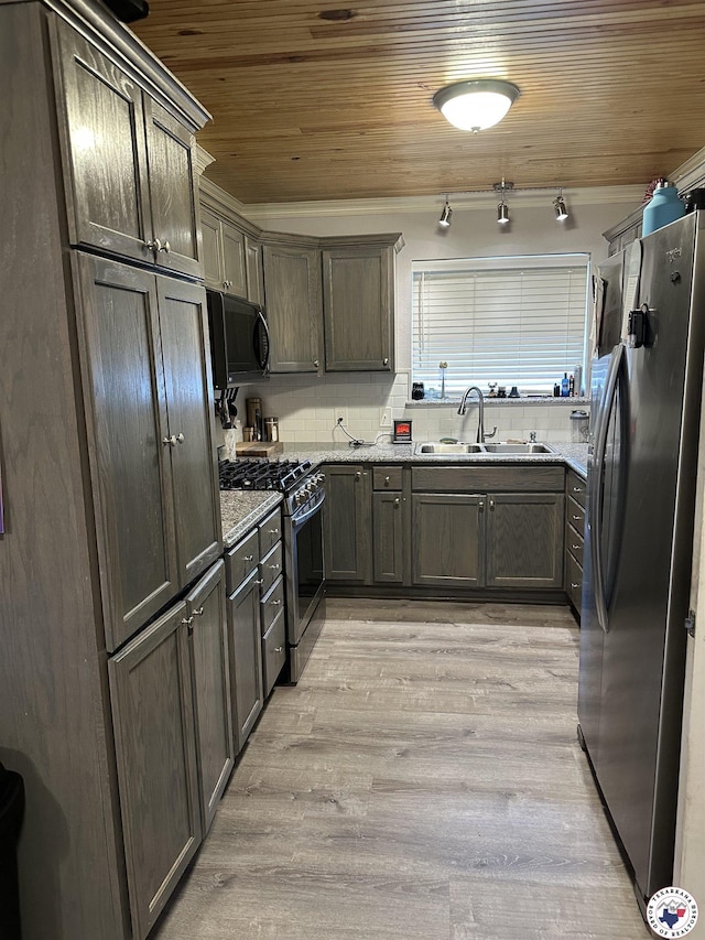1002 Champion St, Texarkana, TX 75503 - kitchen with stainless steel appliances, a sink, wooden ceiling, light wood-style flooring, and light stone counters