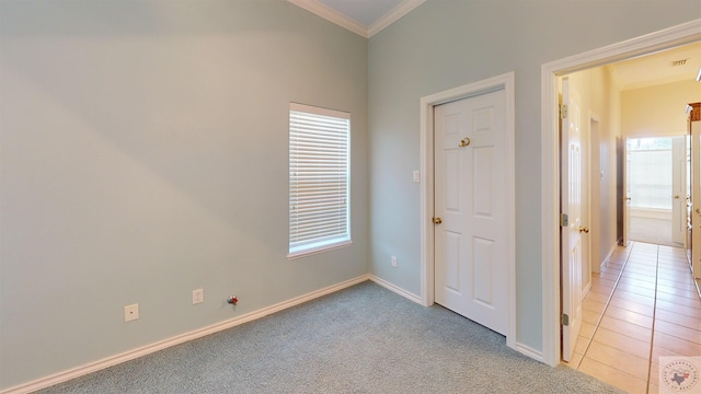 empty room featuring light colored carpet and crown molding