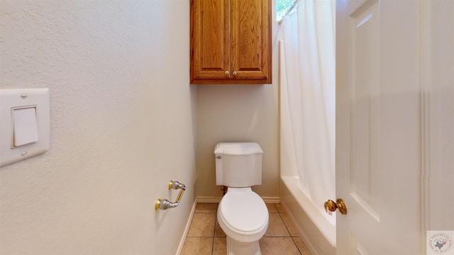 bathroom featuring toilet and tile patterned flooring