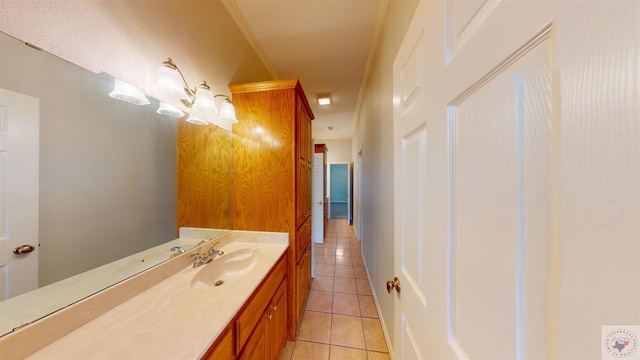 bathroom featuring tile patterned flooring, vanity, and ornamental molding