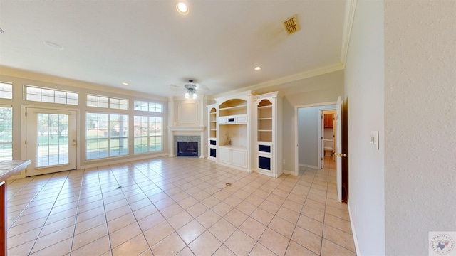 unfurnished living room with light tile patterned floors, ceiling fan, and ornamental molding