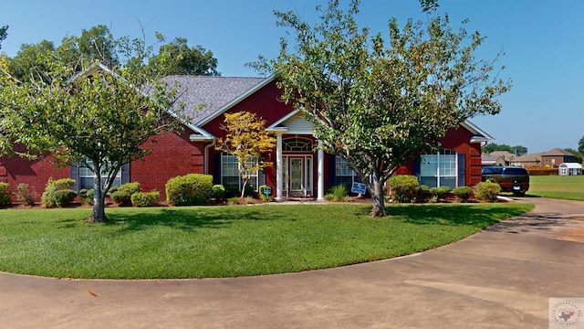 obstructed view of property with a front yard