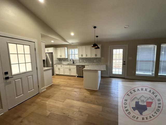 33 Timberlane St, Texarkana, TX 75501 - kitchen with light countertops, white cabinetry, stainless steel appliances, and a sink