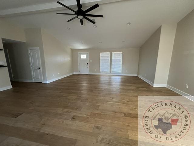 33 Timberlane St, Texarkana, TX 75501 - unfurnished living room featuring baseboards, ceiling fan, vaulted ceiling with beams, and wood finished floors