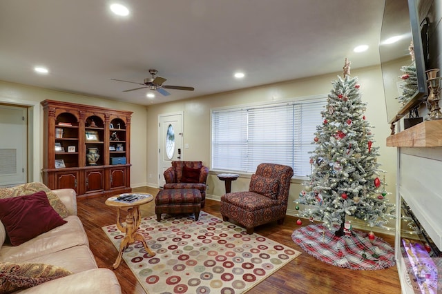 living room with crown molding, ceiling fan, and wood-type flooring