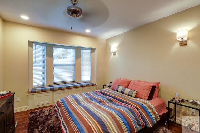 bedroom with dark hardwood / wood-style flooring and ceiling fan