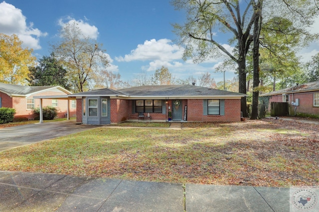 ranch-style home featuring a carport and a front yard