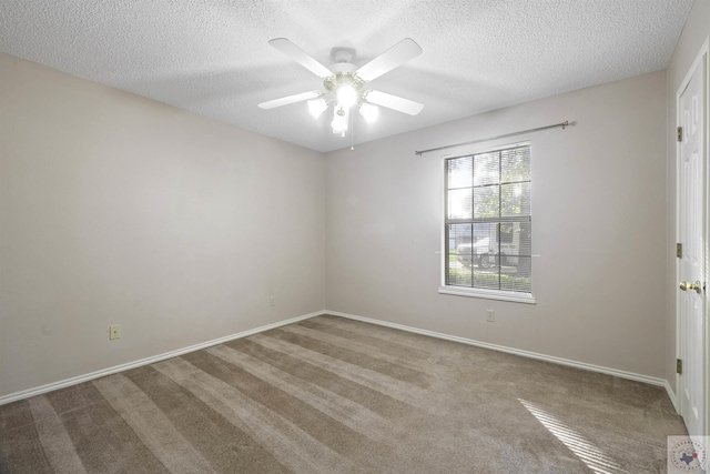 carpeted spare room with a textured ceiling and ceiling fan