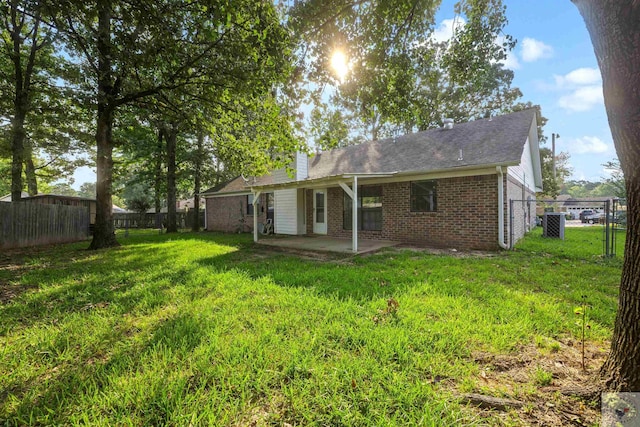 back of property featuring a patio and a lawn