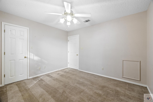 unfurnished room with carpet floors, a textured ceiling, and ceiling fan