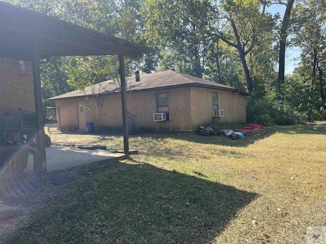 view of side of home with cooling unit, a lawn, and a patio