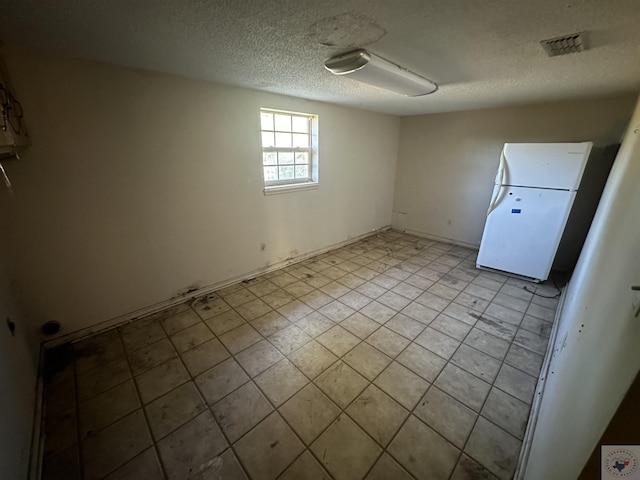 empty room with a textured ceiling