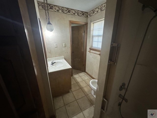 bathroom featuring toilet, vanity, and tile patterned flooring