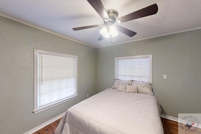 bedroom with ceiling fan, dark wood-type flooring, and ornamental molding