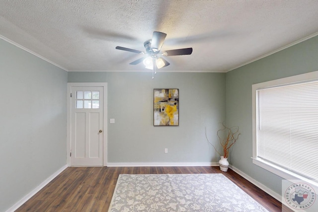 foyer featuring ceiling fan, crown molding, dark wood-type flooring, and a textured ceiling