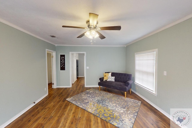 living area with crown molding, dark hardwood / wood-style floors, and ceiling fan