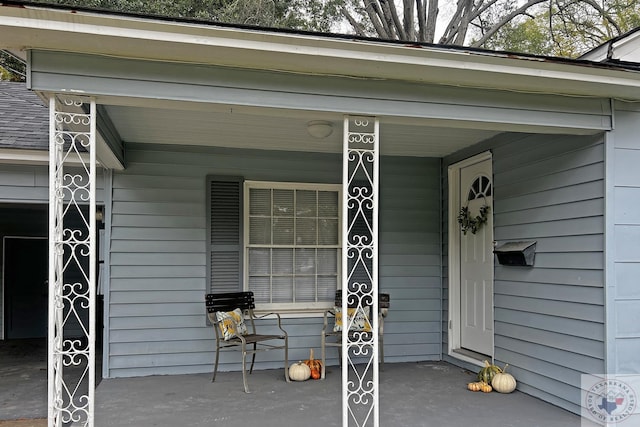 view of exterior entry featuring a porch