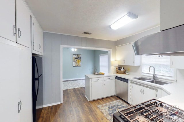 kitchen featuring dishwasher, white cabinetry, sink, black fridge, and dark hardwood / wood-style floors