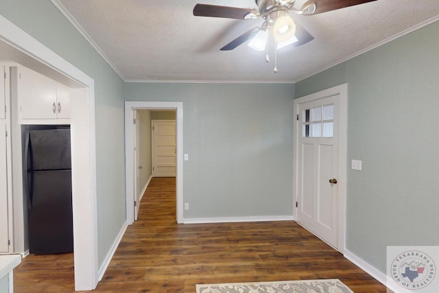 entryway with a textured ceiling, dark hardwood / wood-style floors, ceiling fan, and ornamental molding