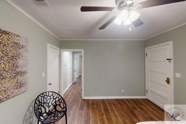 unfurnished room with ceiling fan, dark hardwood / wood-style flooring, and ornamental molding