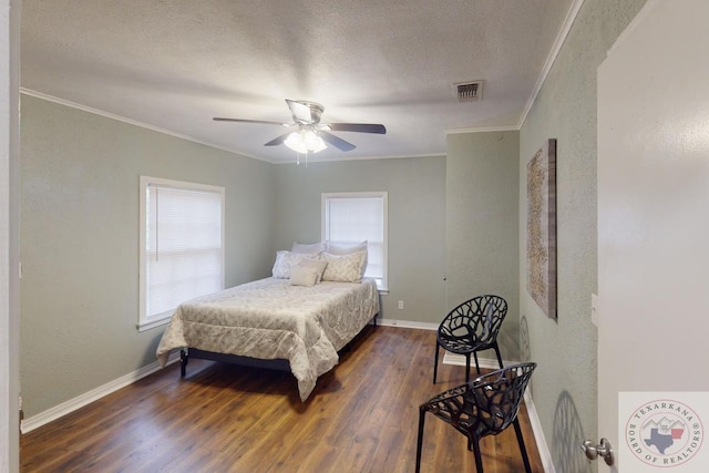 bedroom featuring ceiling fan, dark hardwood / wood-style floors, and ornamental molding