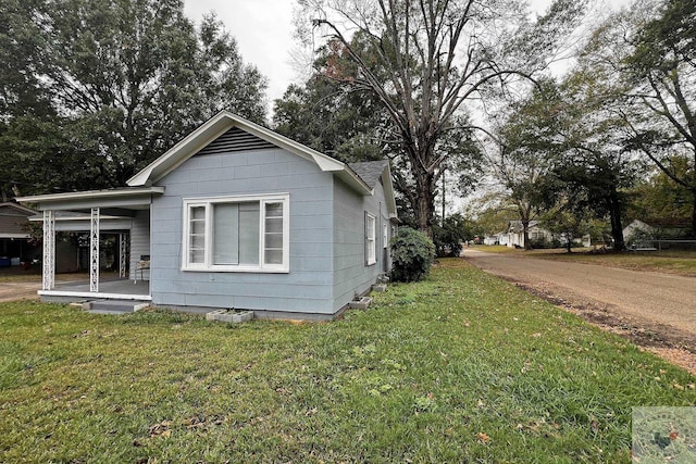 view of side of home featuring a yard