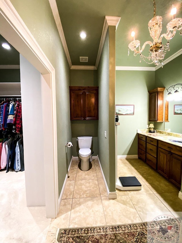 bathroom featuring tile patterned flooring, toilet, baseboards, double vanity, and crown molding