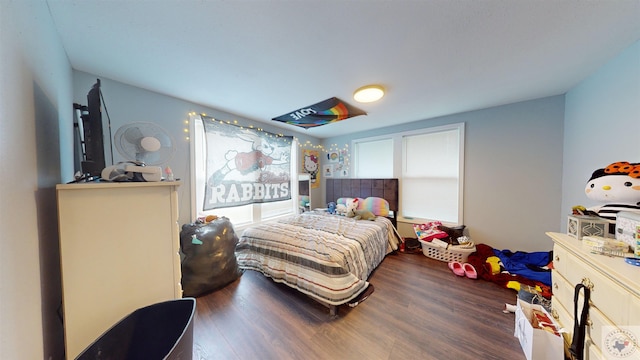 bedroom with dark hardwood / wood-style flooring