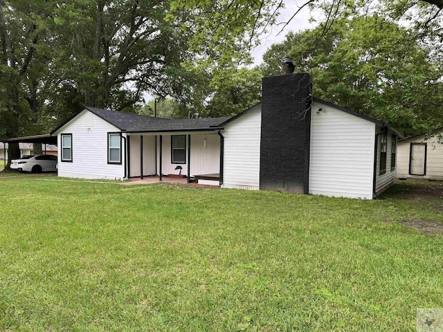 view of front facade featuring a front yard and a carport