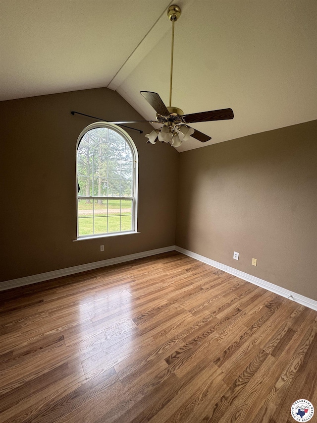 11 Quail Creek Dr, Fouke, AR 71837 - empty room with baseboards, a ceiling fan, wood finished floors, and vaulted ceiling