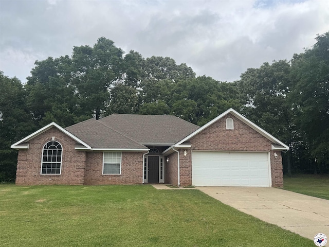 11 Quail Creek Dr, Fouke, AR 71837 - single story home with brick siding, a garage, a front lawn, and driveway