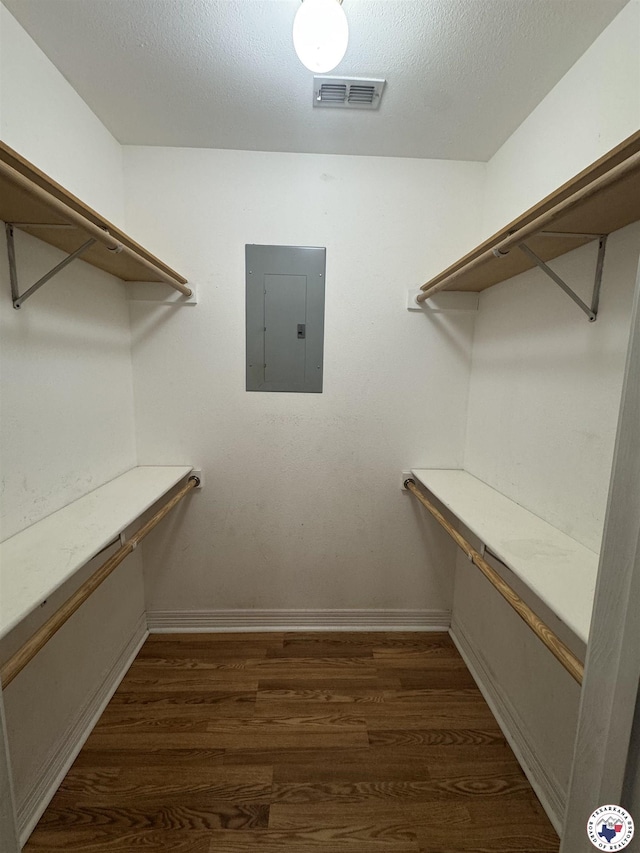 11 Quail Creek Dr, Fouke, AR 71837 - walk in closet with dark wood-style flooring, visible vents, and electric panel