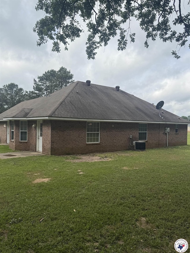 11 Quail Creek Dr, Fouke, AR 71837 - exterior space with a yard, brick siding, central AC, and a patio area