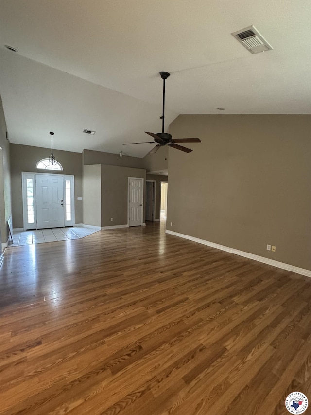 11 Quail Creek Dr, Fouke, AR 71837 - unfurnished living room featuring ceiling fan, visible vents, wood finished floors, baseboards, and lofted ceiling