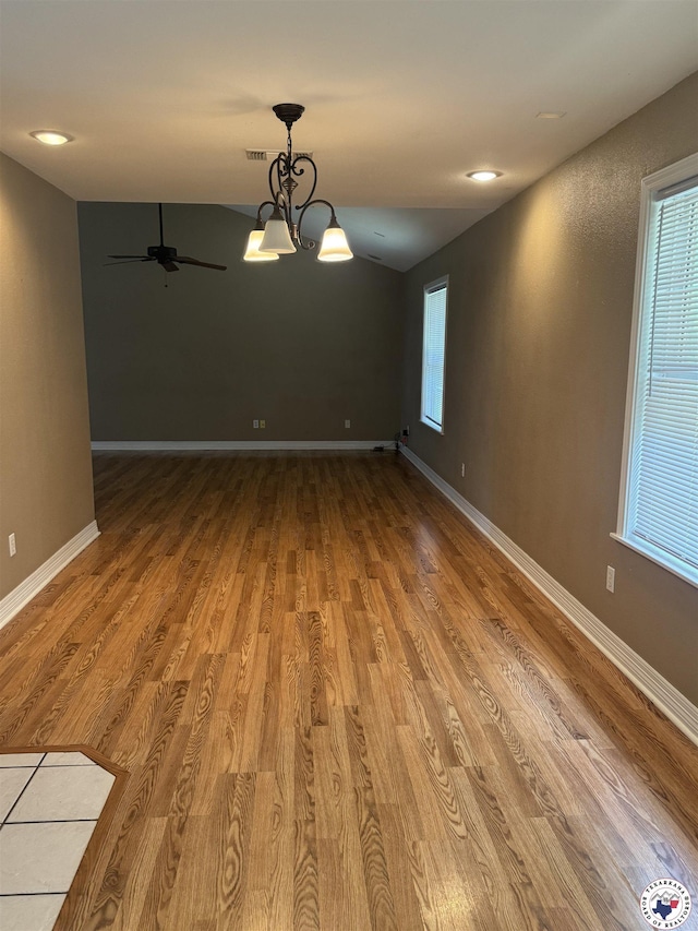 11 Quail Creek Dr, Fouke, AR 71837 - empty room with baseboards, ceiling fan with notable chandelier, wood finished floors, and visible vents