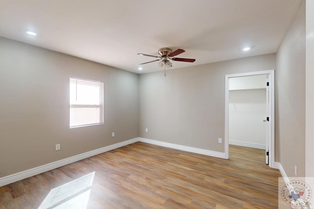 empty room featuring recessed lighting, a ceiling fan, light wood-type flooring, and baseboards