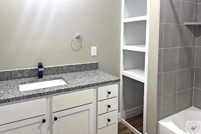 bathroom with vanity and wood finished floors