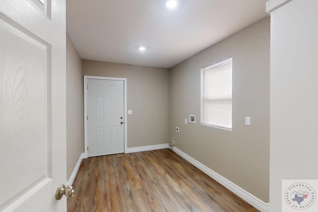 interior space featuring recessed lighting, baseboards, and wood finished floors