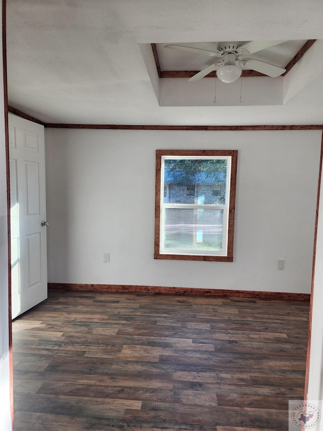 empty room featuring ceiling fan, ornamental molding, and dark hardwood / wood-style floors