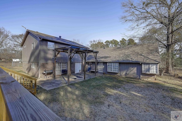 back of house with a patio, a pergola, and a lawn