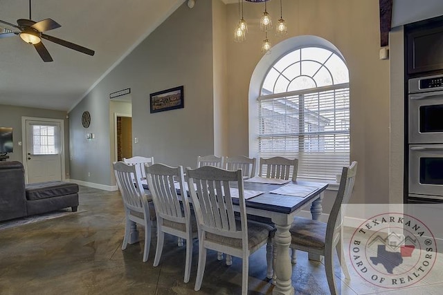 dining space featuring high vaulted ceiling and ceiling fan