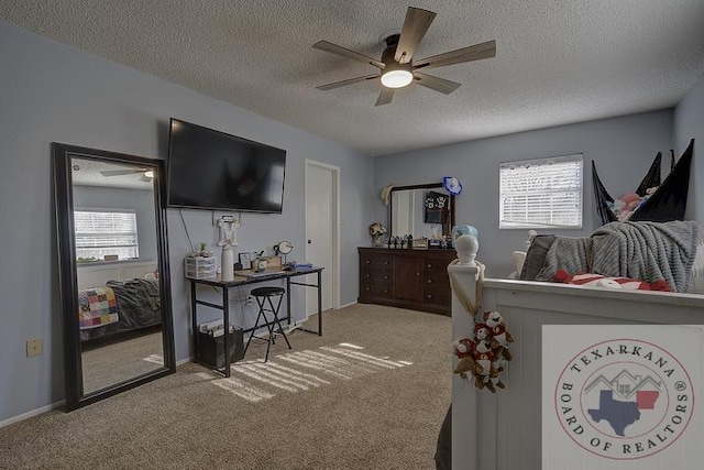 bedroom with ceiling fan, light colored carpet, and a textured ceiling