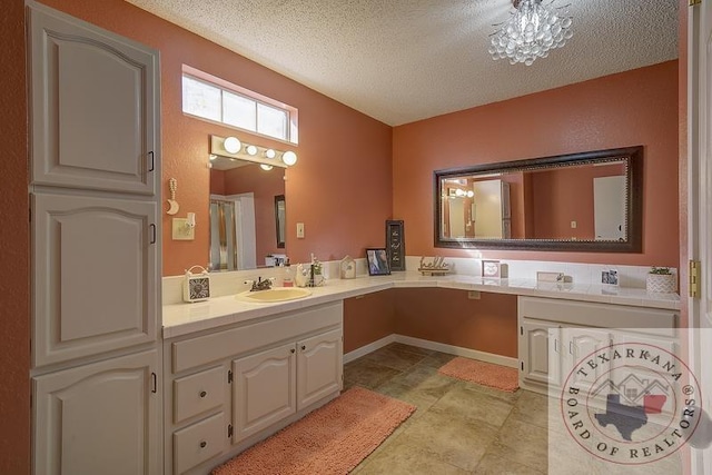 bathroom featuring a textured ceiling and vanity