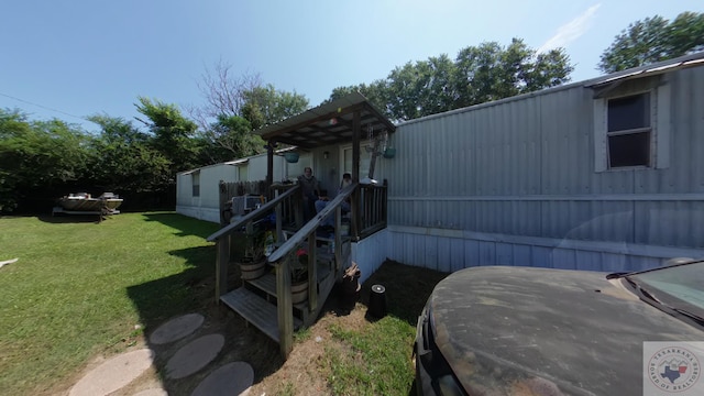 view of side of property with a lawn